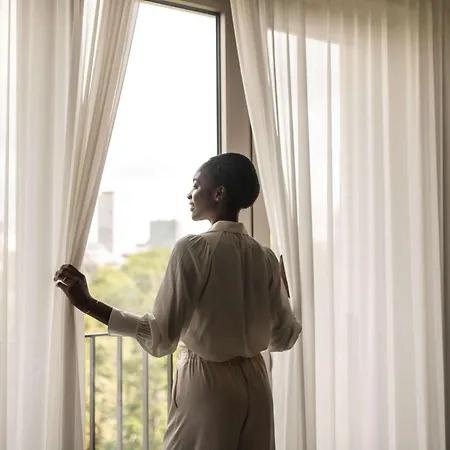 Sofitel Frankfurt Opera Hotel Frankfurt am Main Exterior photo A woman opening a curtain